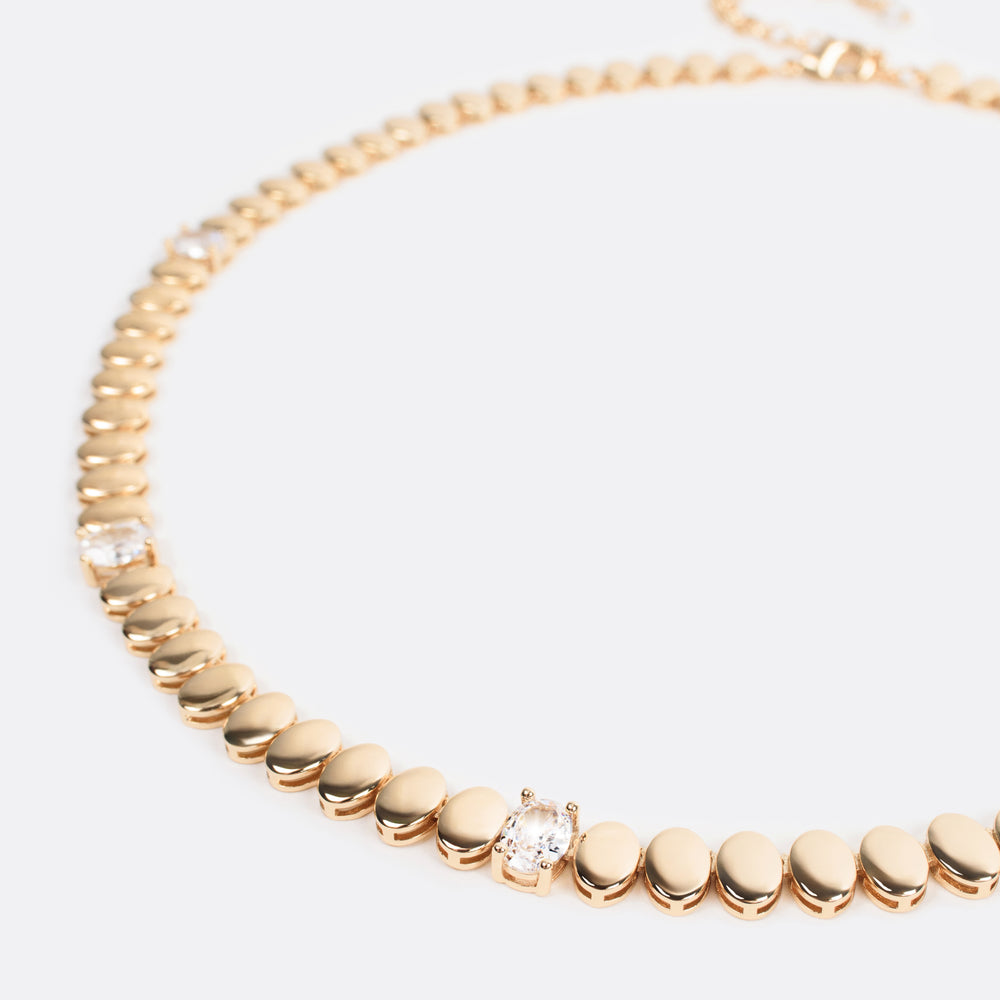 
                  
                    Close-up of the Gilded Harmony Necklace, featuring interlocking gold beads and radiant diamonds, blending timeless sophistication with modern allure.
                  
                