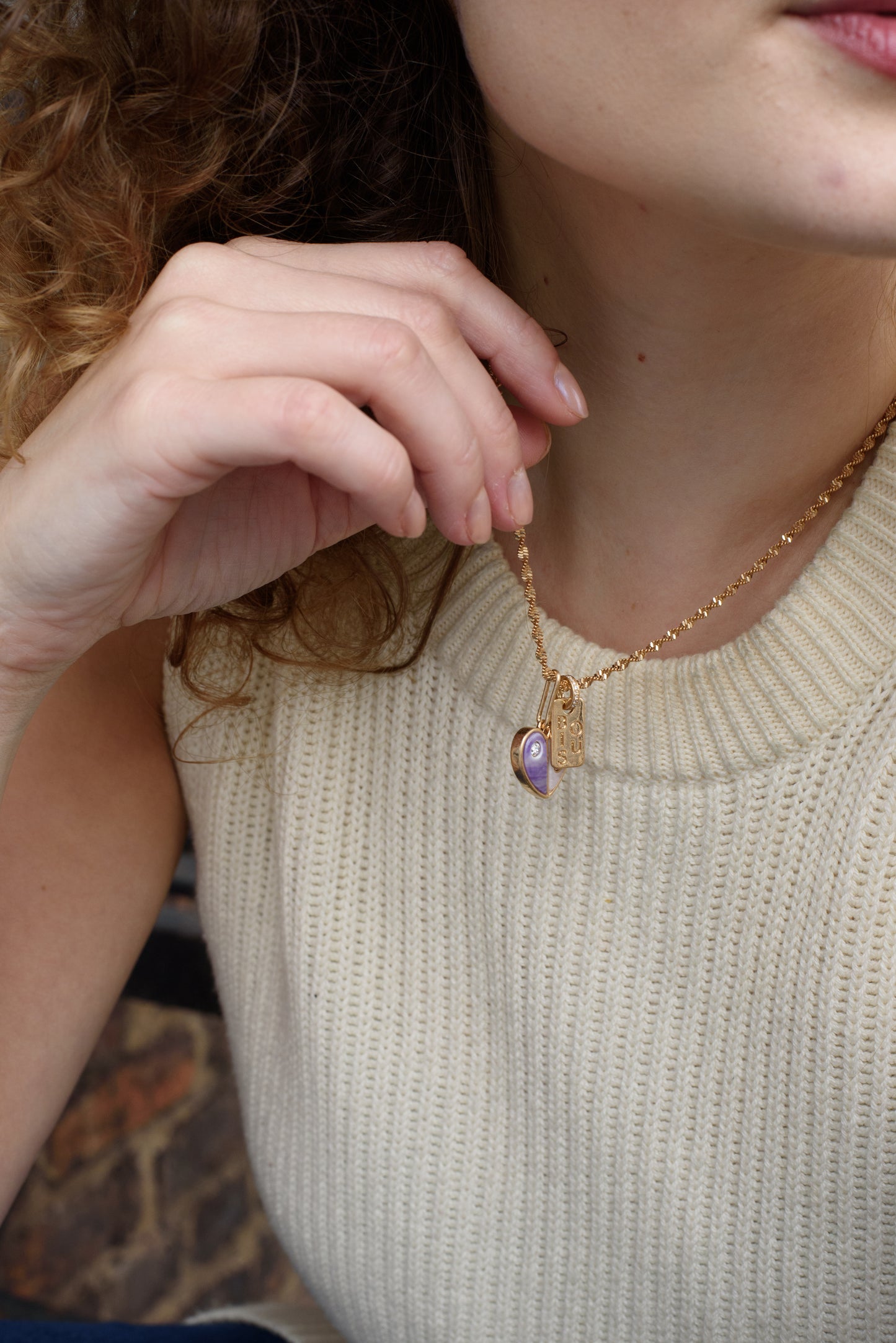 Embrace self-love with the Love Yourself Necklace, featuring a stunning two-tone heart crafted from brass with purple and pearl colored stone inlays. Each side of the heart is adorned with a sparkling zircon stone, symbolizing the balance between strength and tenderness. Paired with the matching Bisous bangle, this necklace is a reminder to cherish yourself and celebrate your unique journey. Designed for versatility, it can be worn alone or layered to inspire confidence and radiance in every version of you.