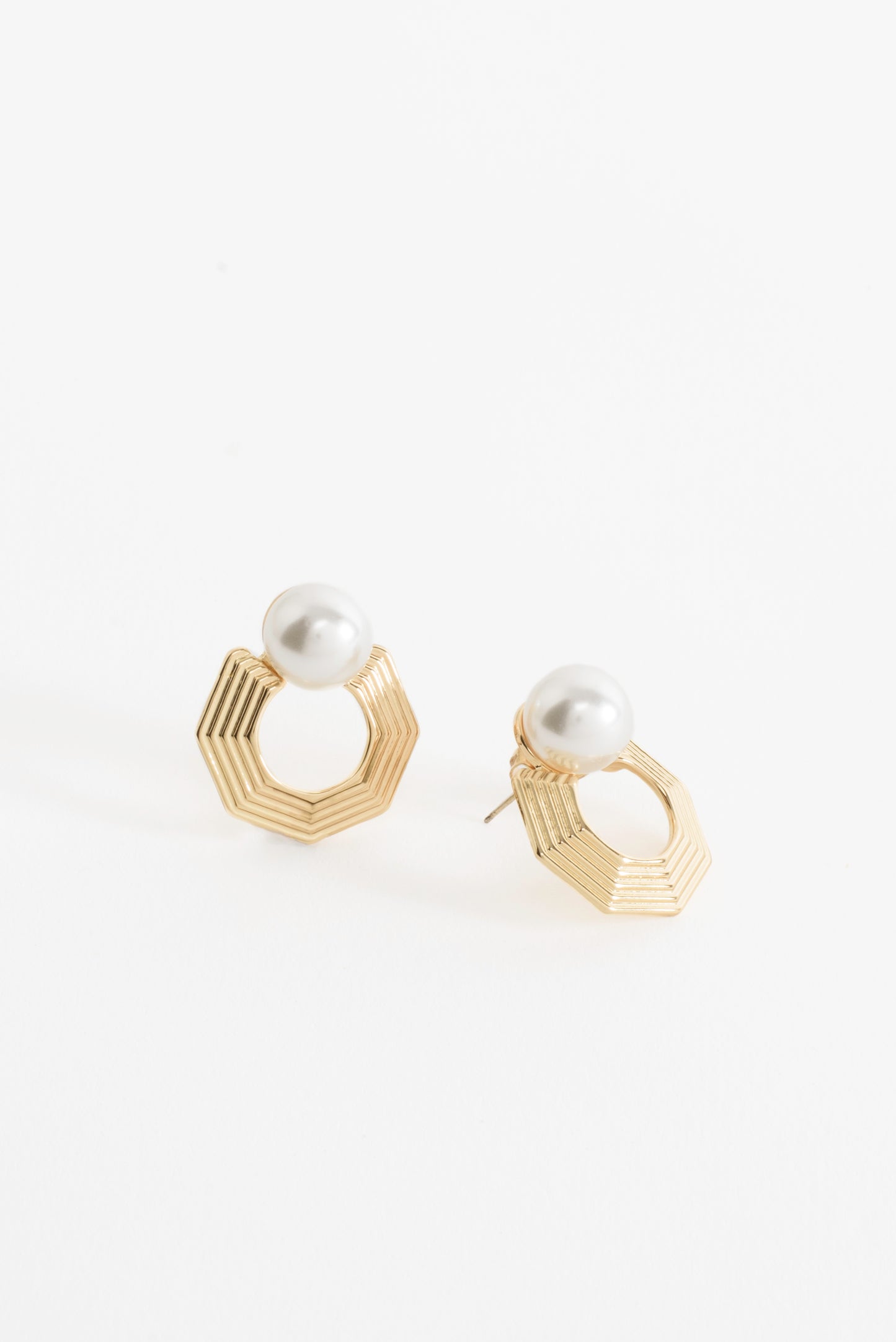 Close-up of the Harmony Hex Drop Earrings, featuring a sleek hexagon silhouette with a delicate pearl drop, blending geometric strength with timeless elegance.