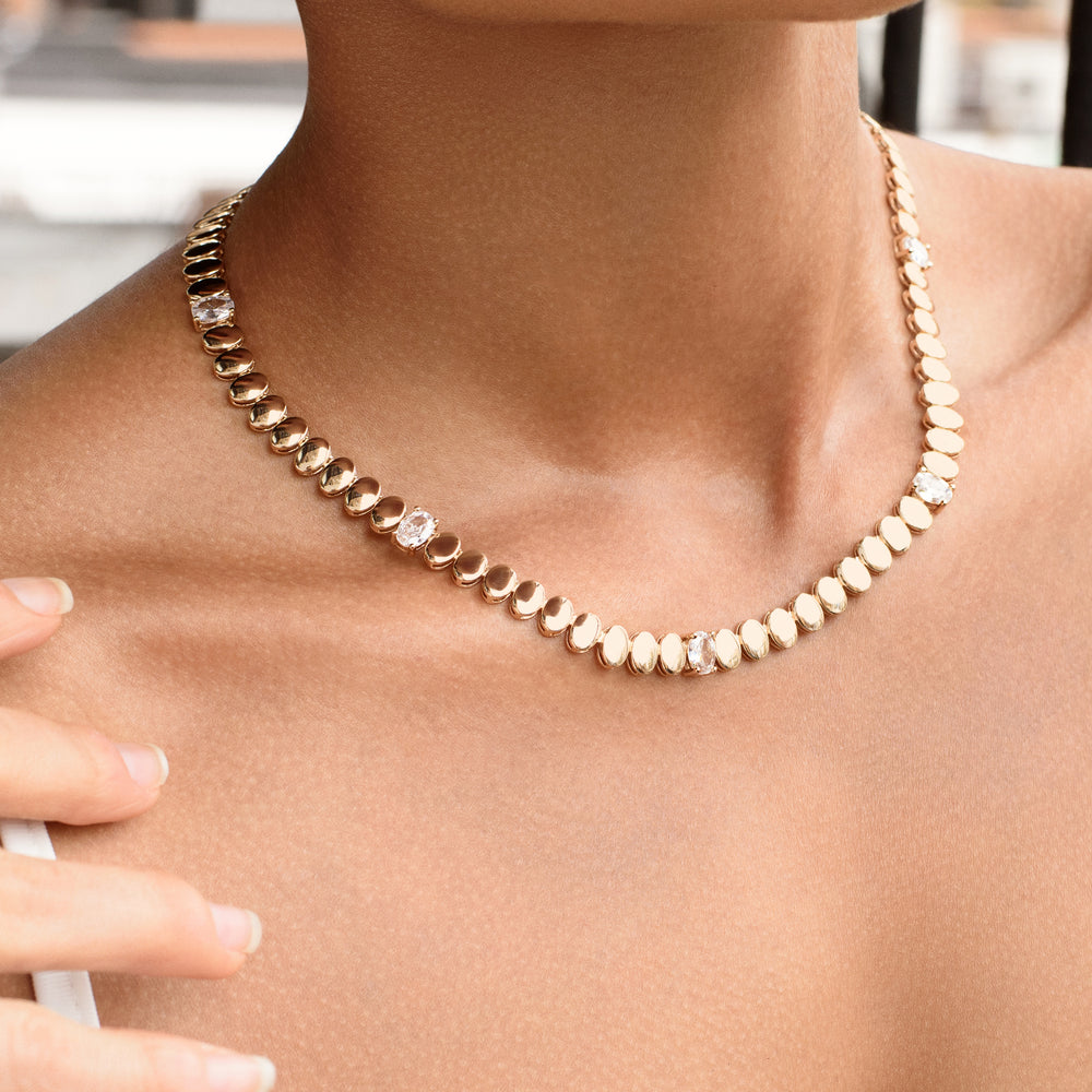 Close-up of the Gilded Harmony Necklace worn on a model, featuring interlocking gold beads and radiant diamonds, blending timeless sophistication with modern allure.