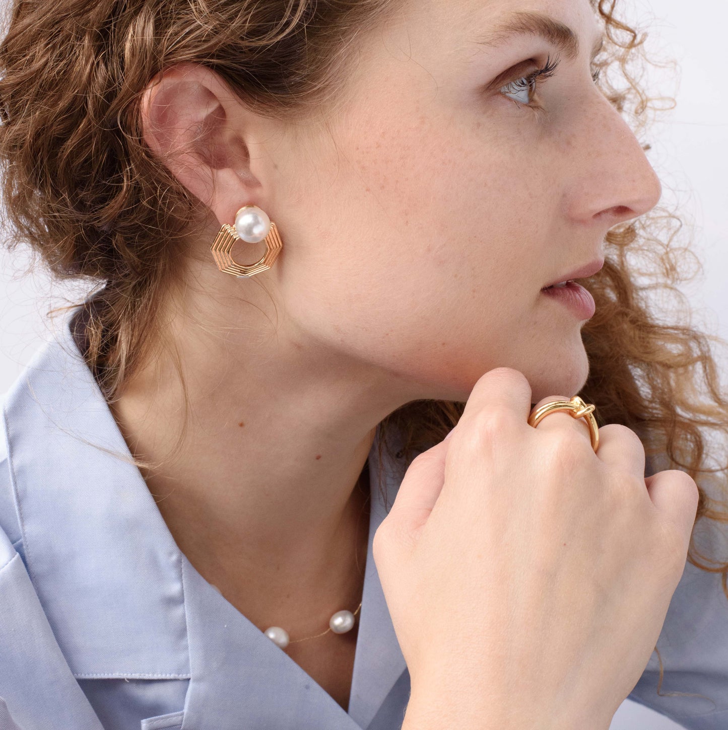 Close-up of Harmony Hex earring, a delicate hexagonal-shaped earring with a polished finish, designed for an elegant and modern look.