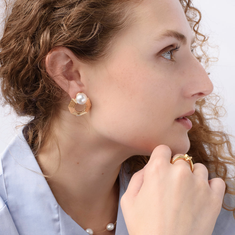 Close-up of the Harmony Hex Drop Earrings on model, featuring a sleek hexagon silhouette with a delicate pearl drop, blending geometric strength with timeless elegance.