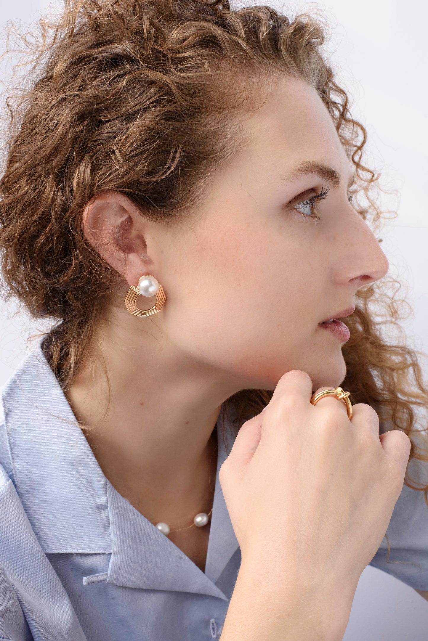 Close-up of the Harmony Hex Drop Earrings on model, featuring a sleek hexagon silhouette with a delicate pearl drop, blending geometric strength with timeless elegance.